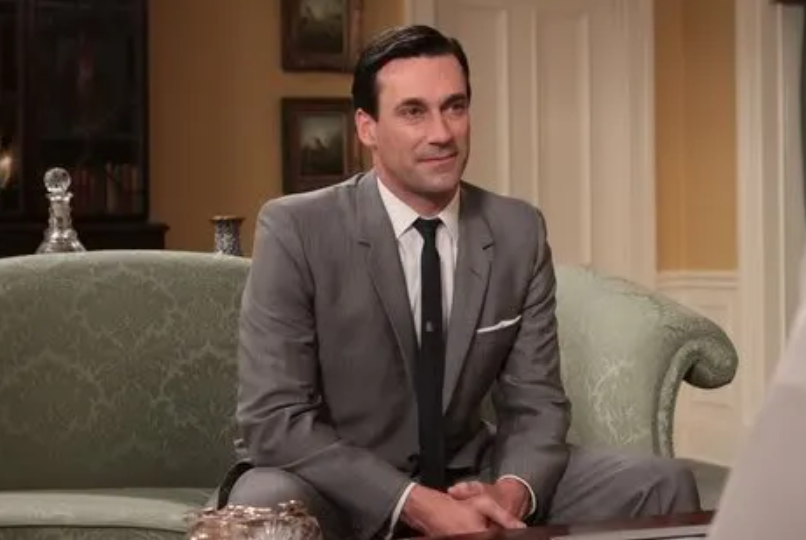 Mad Men - Don draper sitting on green couch